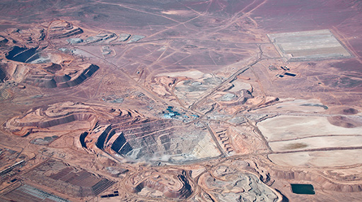 Coherent modeling of mineral grades and zones by coupling cokriging and Support Vector Machine